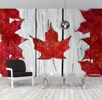 Bild på Canadian flag made of red maple leaves over a weathered white wood background